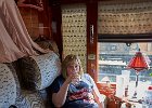 Lynne relaxing and enjoying a drink in our compartment